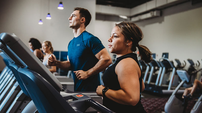 man-and-woman-working-out-on-treadmills
